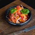 Tomato Salad in Plate Beside Knife