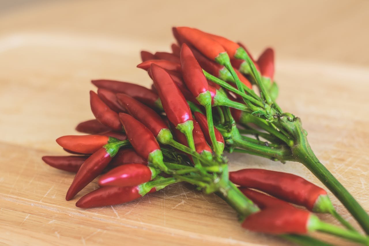 Red Chili Peppers on Brown Wooden Surface